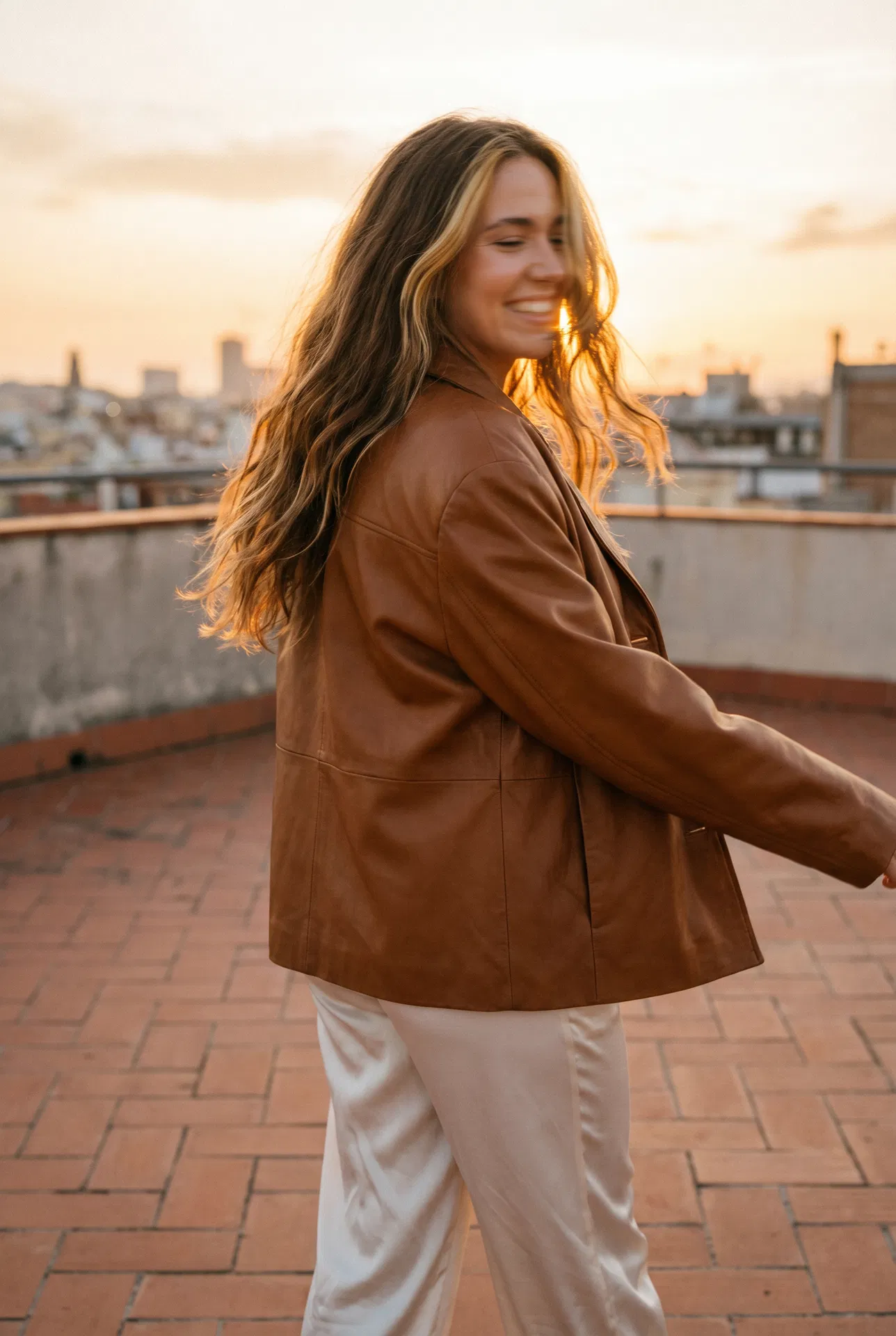 Doublure — Zora Wisp Weft model, warm brown hair with golden highlights on rooftop terrace at golden hour